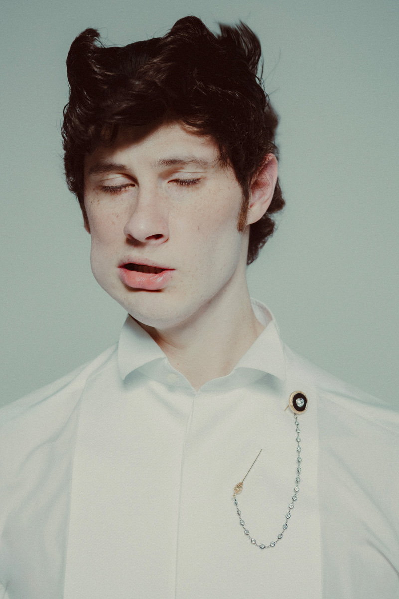 Imagem da esquerda: Juan Pablo: fato, SAINT LAURENT BY ANTHONY VACCARELLO. Camisa, GREGORIO CAYETANO. Sapatos, DOLCE & GABBANA. Emilio: full look, PRADA. Imagem da direita: Julien: camisa e alfinete, DOLCE & GABBANA. 